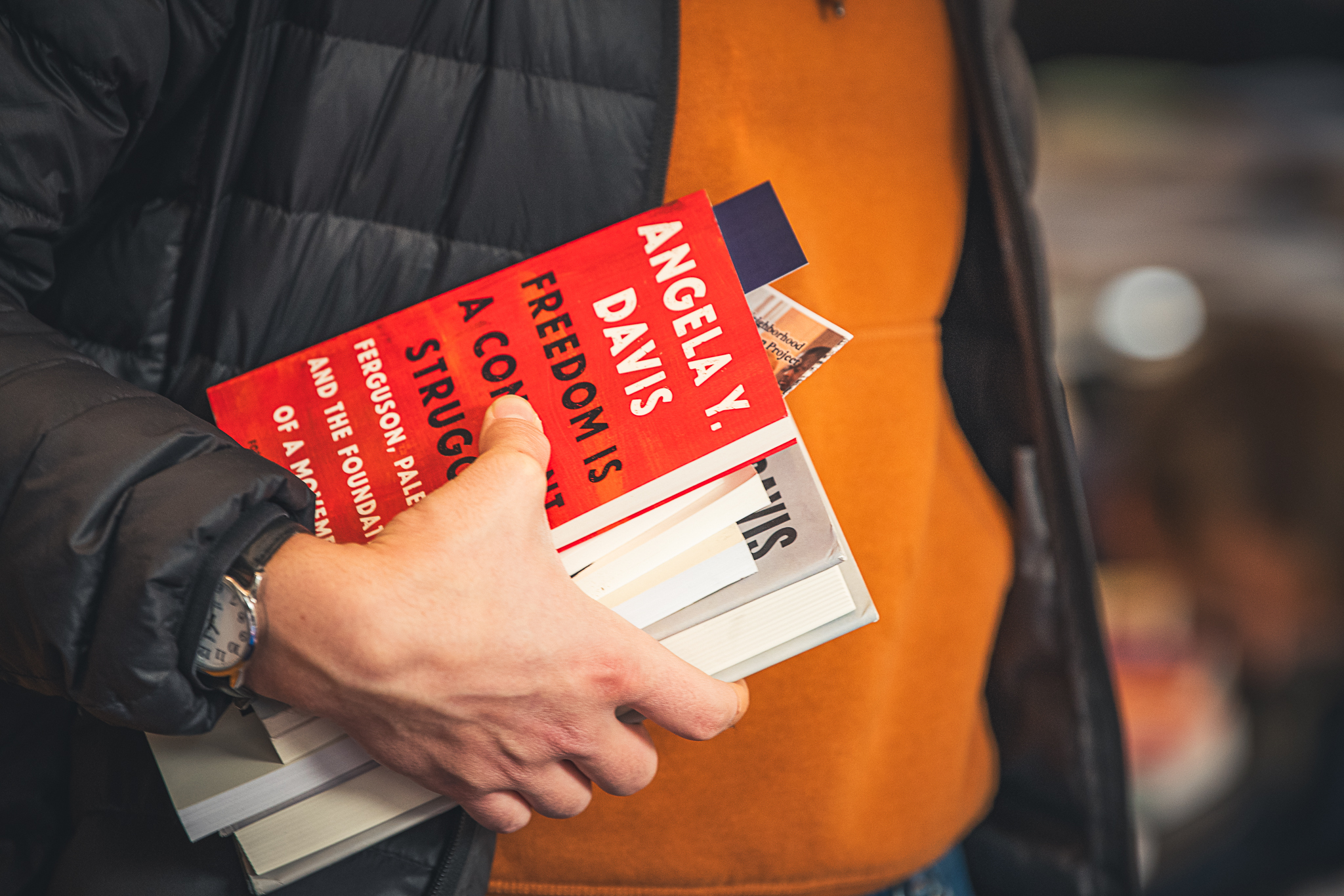 A person carrying a stack of books.