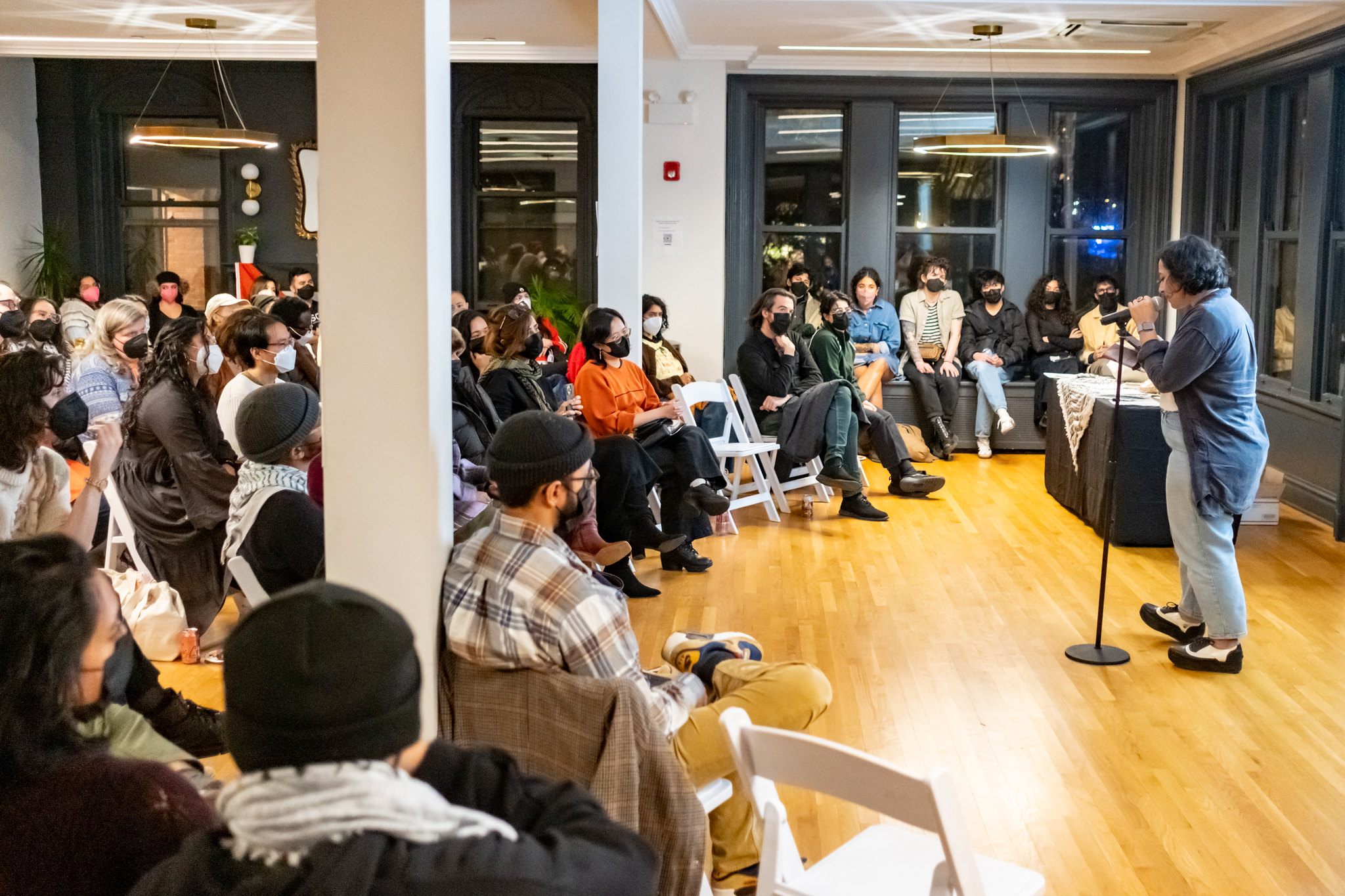 A speaker addressing a full room of people at Haymarket House.