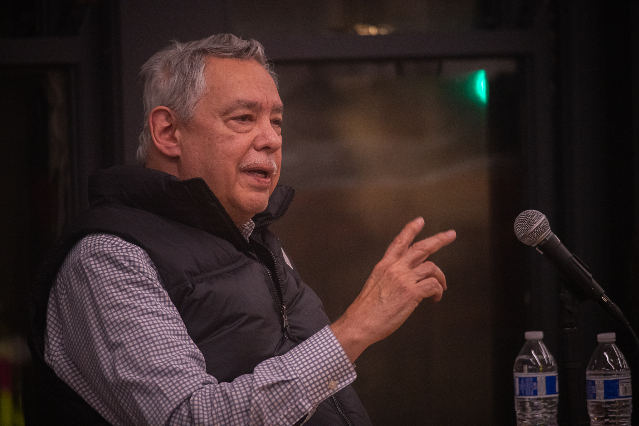 A speaker addresses an audience from a Haymarket panel.